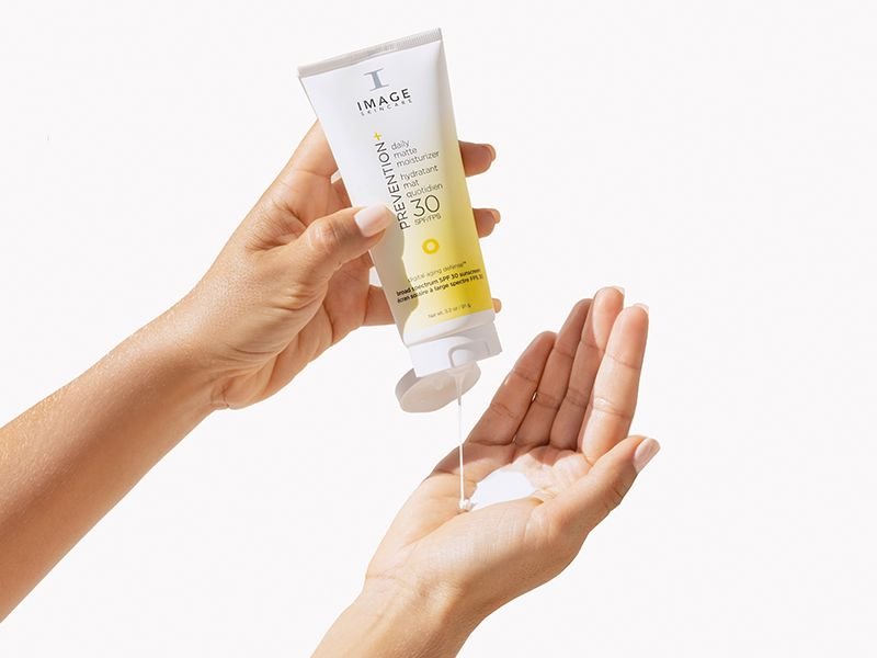 Woman applying gentle moisturizer to sensitive face skin for redness relief